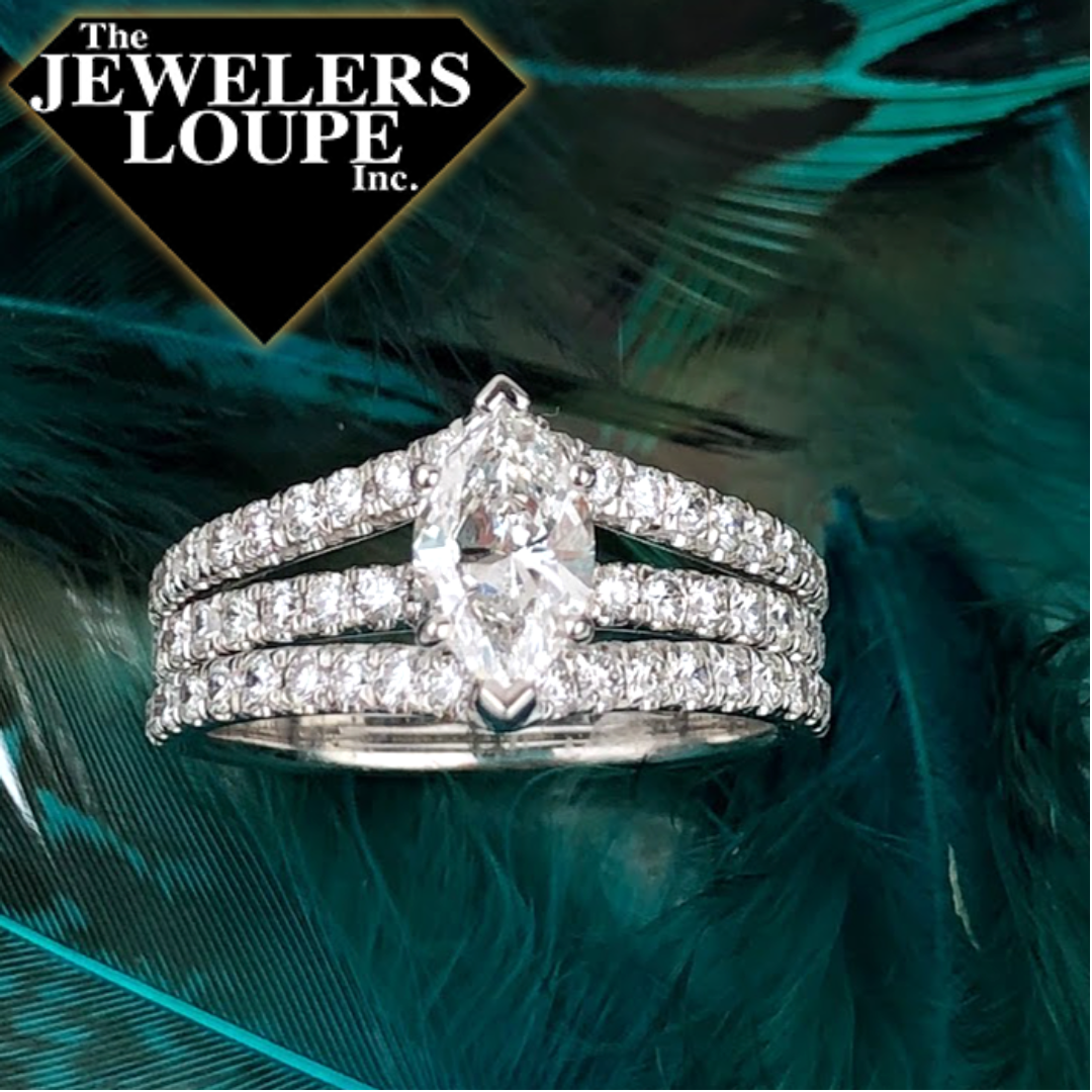 Diamond engagement ring set with a .71ctw VS2 F Marquise shaped center stone and .91ctw in the three row mounting in 14K White Gold.