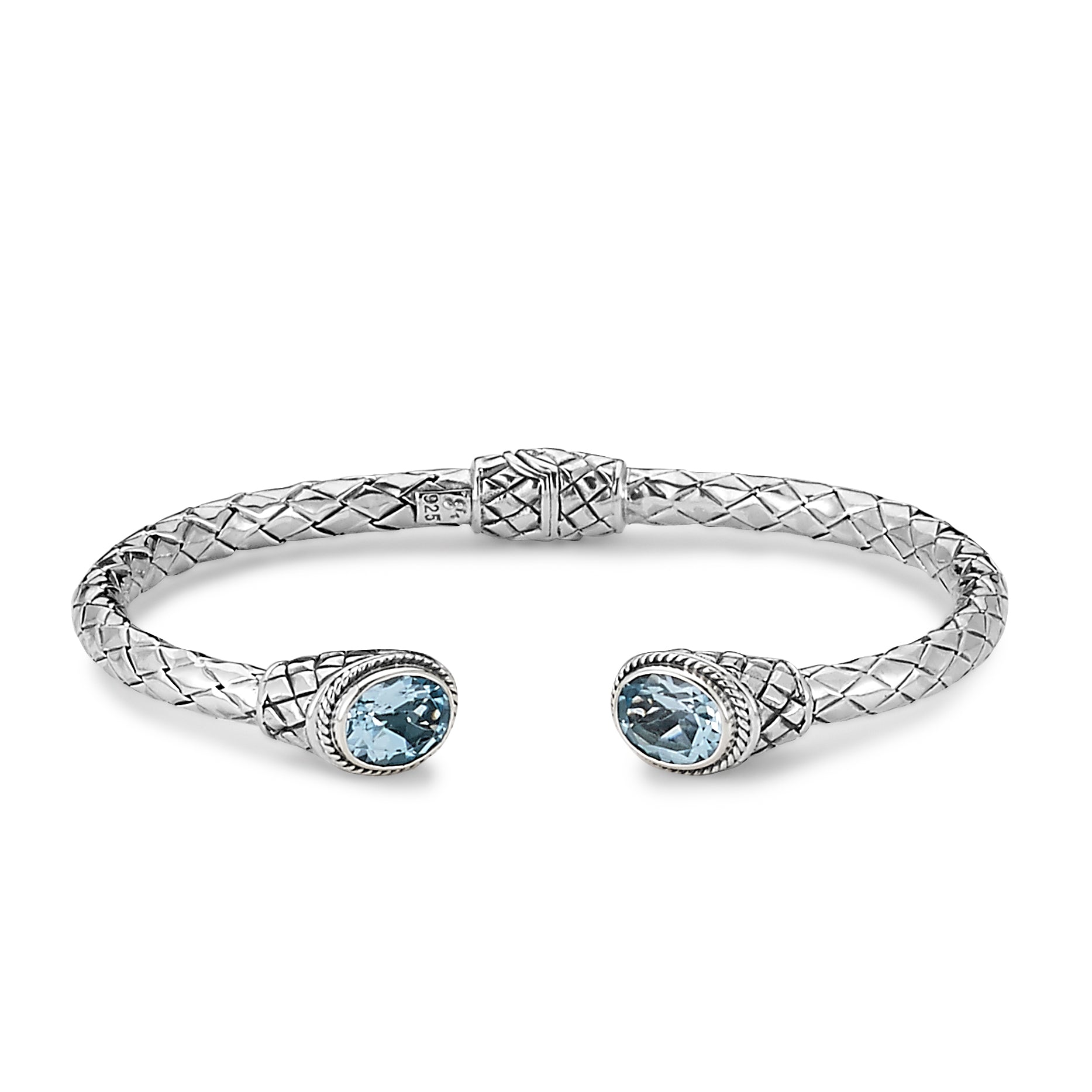 Samuel B. Sterling Silver Oval Blue Topaz Woven Design Hinged Sanur Bracelet. Our Sterling Silver oval blue topaz woven design hinged bangle, handcrafted in Bali by our skilled artisans. From our signature collection, Royal Bali™ featuring designs handcrafted using sterling silver and genuine gemstones.