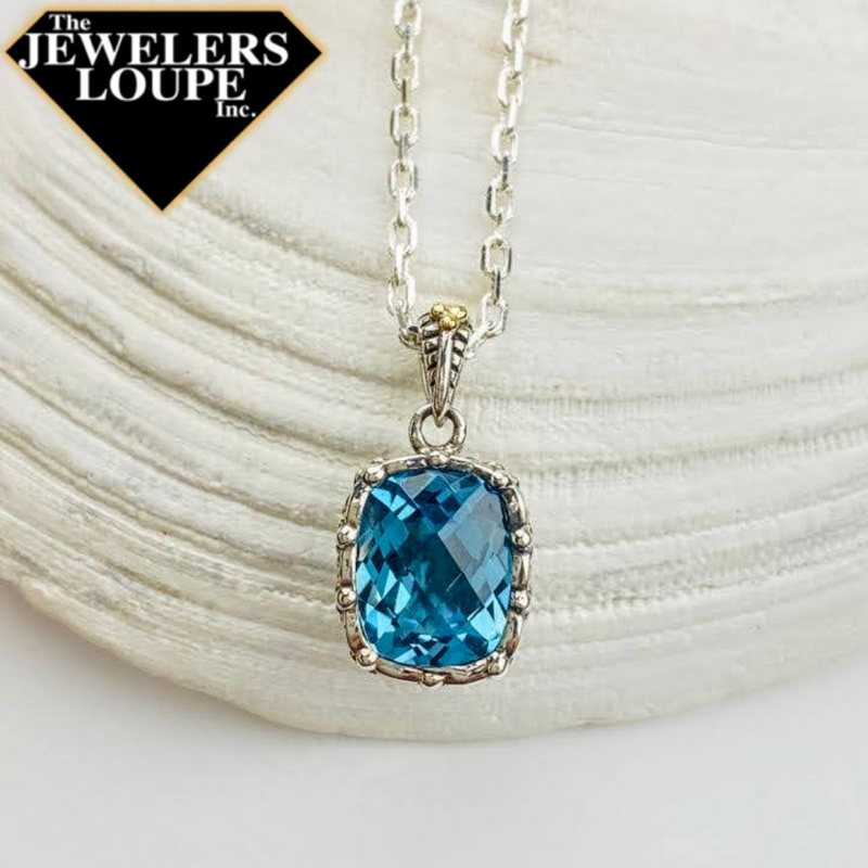 Jeanex Sterling Silver Pendant set with 2.67ctw Checkerboard Cushion Cut Blue Topaz and 18K Yellow Gold accented bail.