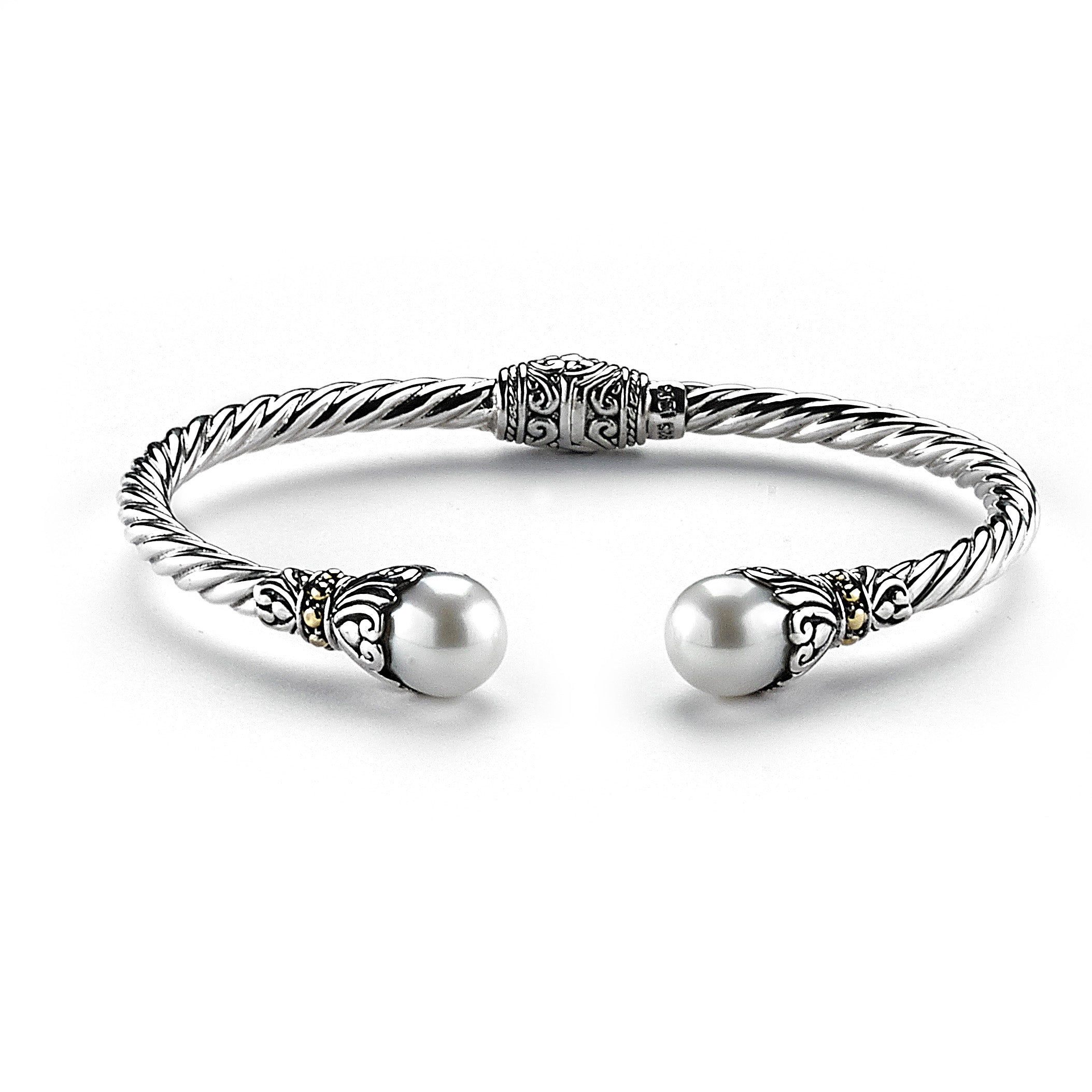 Samuel B. Sterling Silver and 18K Yellow Gold Cable Style Fresh Water Bangle. Our Sterling Silver 18k solid Gold 3mm twisted cable bangle with pearl endcaps, handcrafted in Bali by our skilled artisans. The Gems of the Sea collection is inspired by the beauty of the white beaches, sparkling sea and the flourishing coral reefs of Bali.