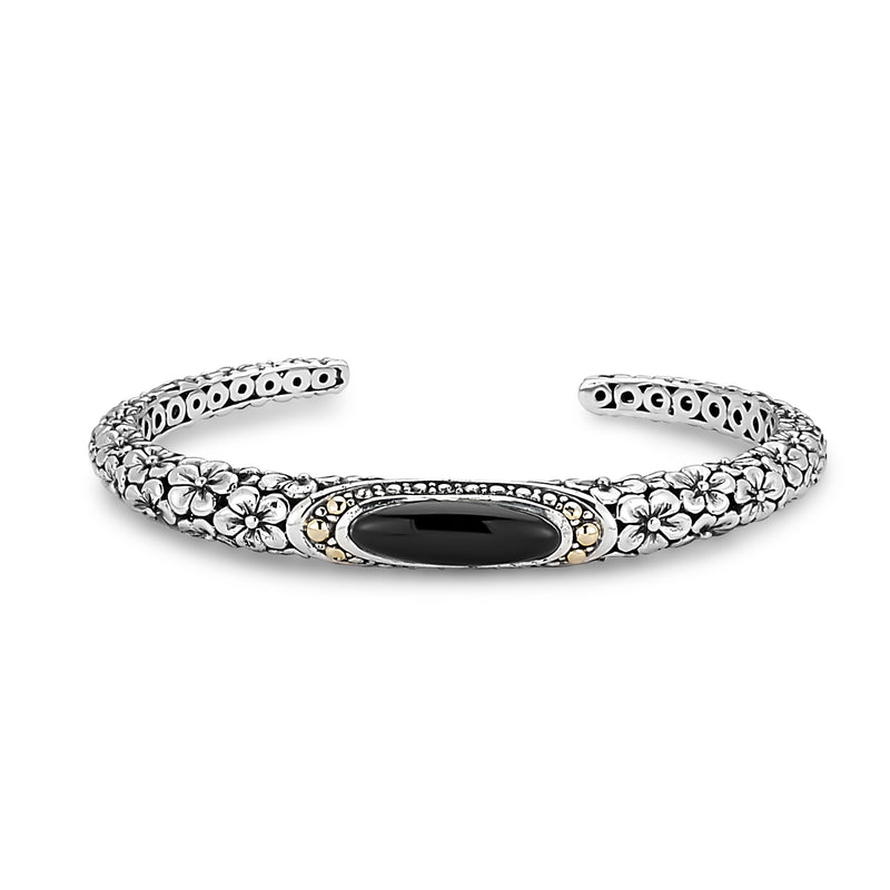 Samuel B. Sterling Silver and 18K Yellow Gold Ijen Floral Design Hinged Bracelet with Oval Black Onyx. Our Sterling Silver 18k solid Gold oval black onyx floral design bangle, handcrafted in Bali by our skilled artisans. From our signature collection, Royal Bali™ featuring designs handcrafted using sterling silver, solid 18k gold accents and genuine gemstones.