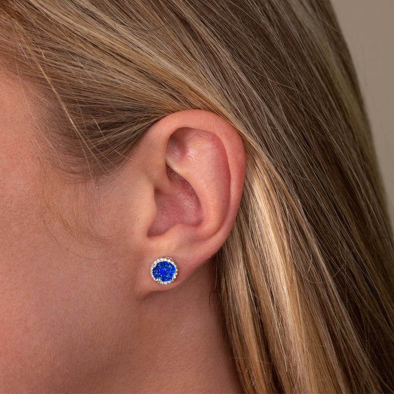 From the Anastasia Collection by Anna Zuckerman Luxury, Sterling Silver Sapphire Blue CZ Halo Stud Earrings.