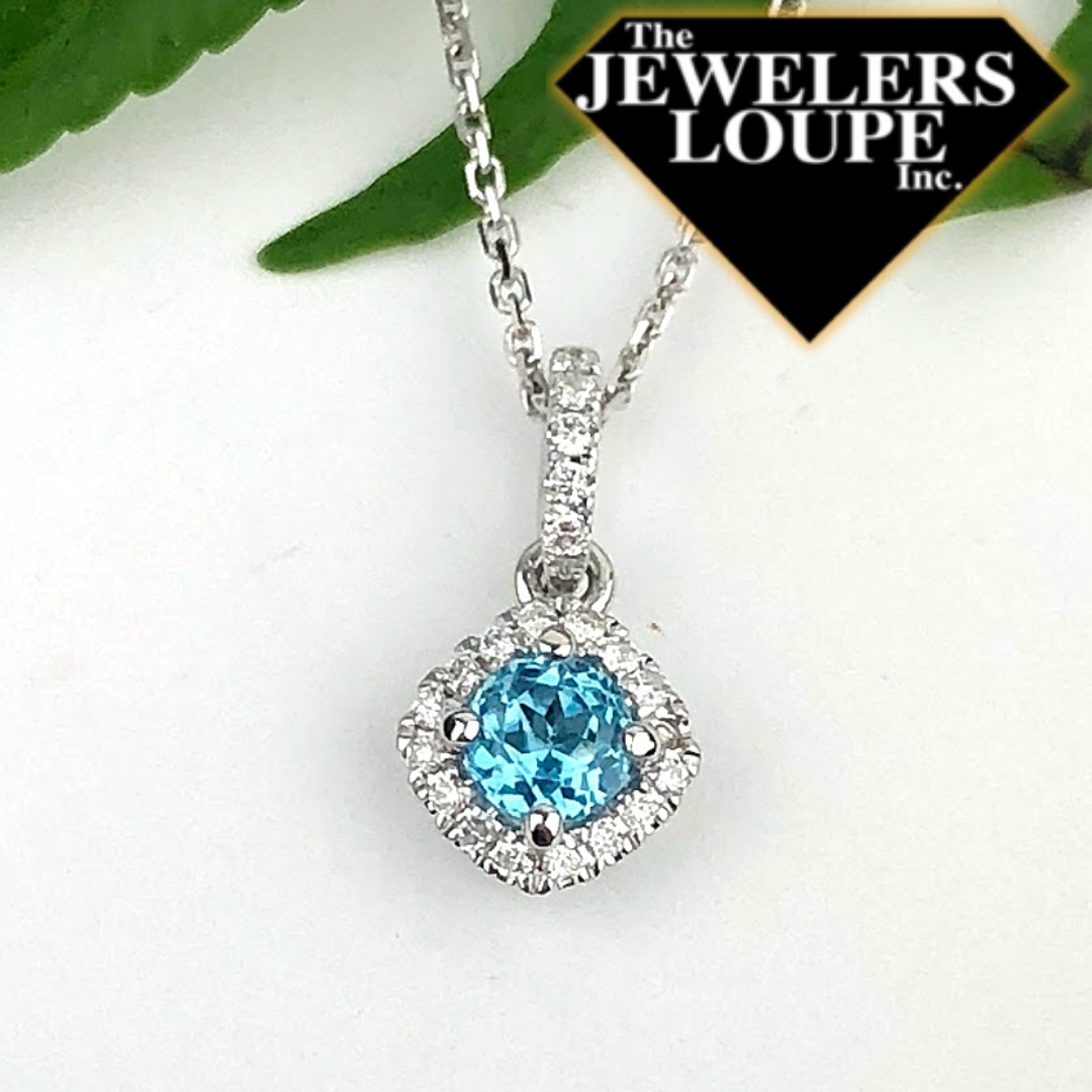 Delicate Pendant set with .30ctw Blue Topaz and .10ctw Diamonds in 14K White Gold with 18" 14K White Gold Chain.