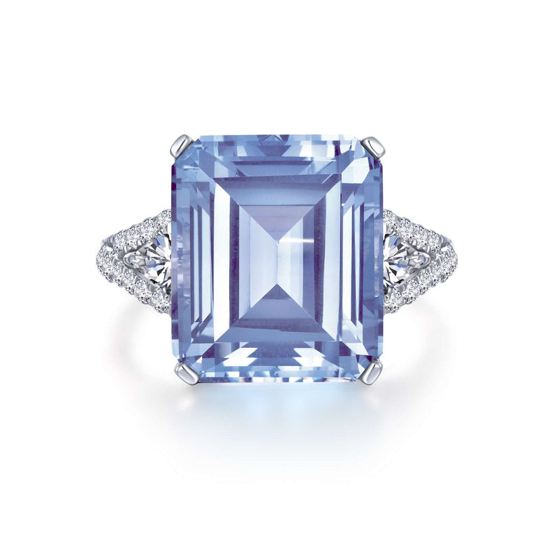 Elegant and sophisticated. This stunning beauty features a Lafonn emerald-cut simulated aquamarine with trillion-cut simulated diamonds on the sides and round simulated diamonds on the shank. This ring is set in sterling silver bonded with platinum.
