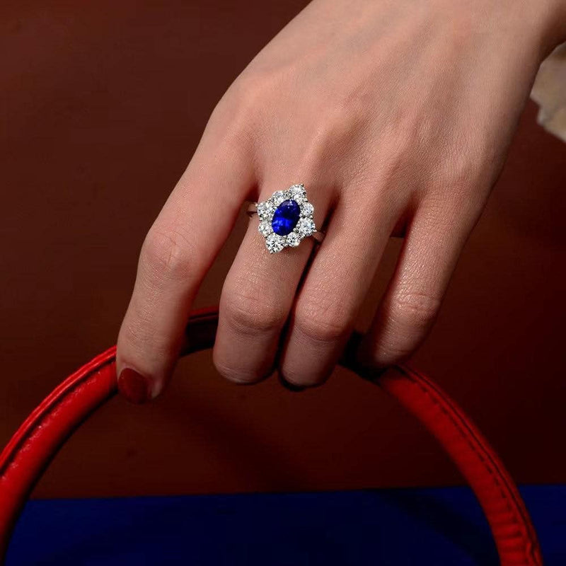From the Victoria Collection by Anna Zuckerman, Elegant 1.5 carat sapphire blue crystalline oval in a halo of round diamond white round crystalline 5 tcw set in platinum plated sterling silver 925
