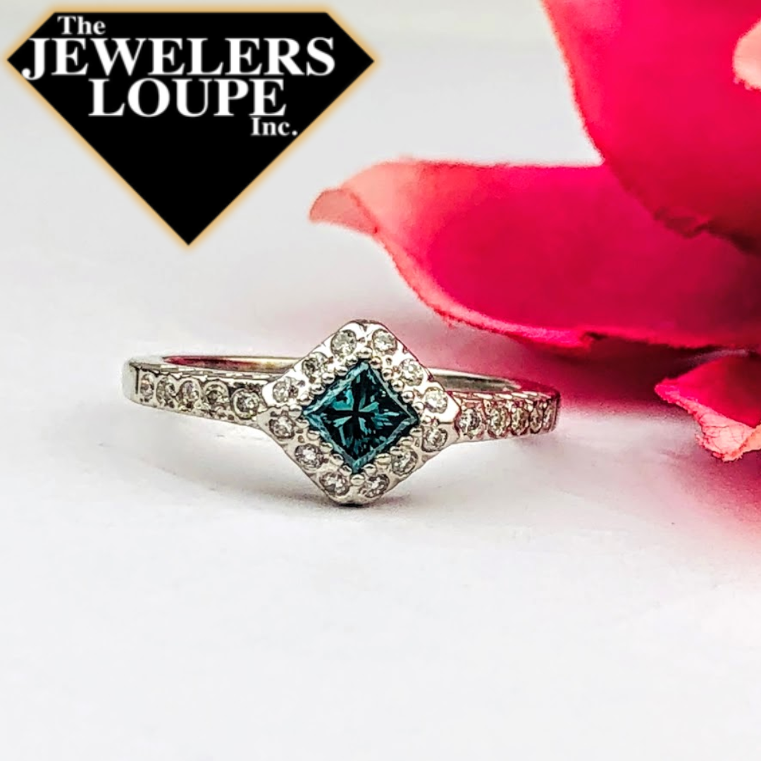 Halo Style Ring with .47ctw Princess Cut Color Enhanced Blue Diamond and .25ctw White Diamonds in Halo and on the shank set in 14K White Gold.