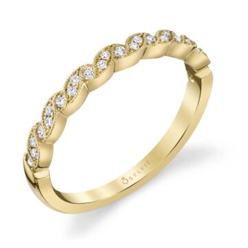 Swirls of milgrain beaded ribbons flow around dazzling round brilliant diamonds to create this magical ribbon inspired yellow gold stackable wedding band. Place this diamond band next to your Sylvie engagement ring as a wedding set or stack it with other favorite bands of different designs, colors, and texture to create your own fashion forward look. The total weight of this stackable band is 0.14 carats.