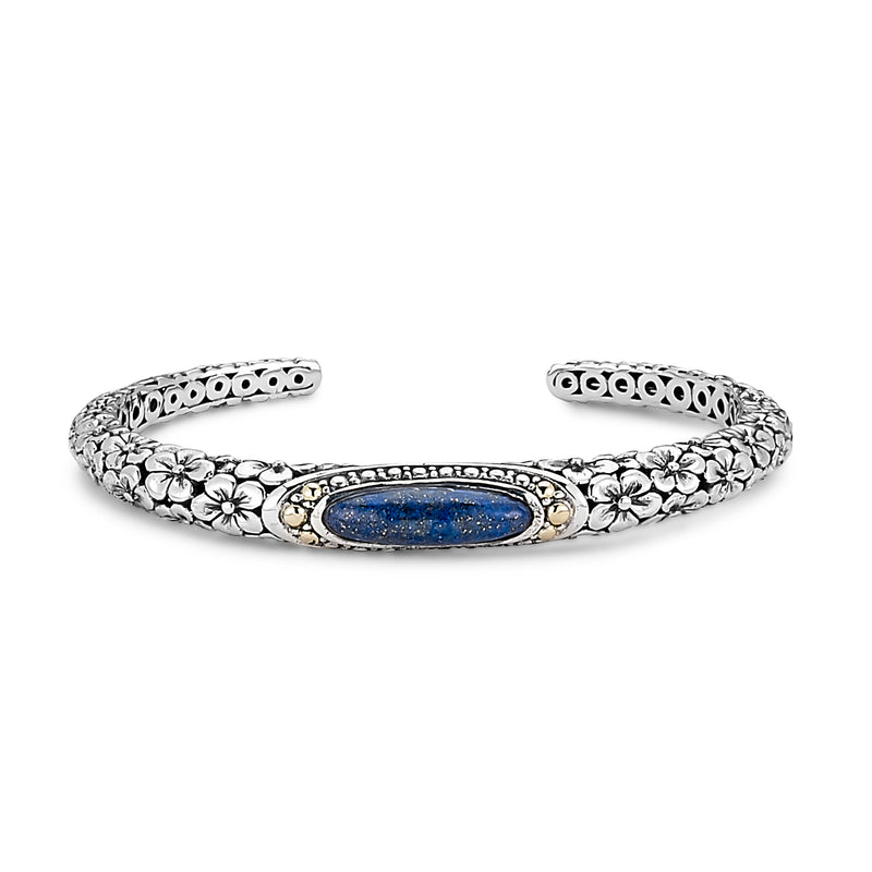 Samuel B. Sterling Silver and 18K Yellow Gold Ijen Floral Design Hinged Bracelet with Oval Lapis. Our Sterling Silver 18k solid Gold oval lapis floral design bangle, handcrafted in Bali by our skilled artisans. From our signature collection, Royal Bali™ featuring designs handcrafted using sterling silver, solid 18k gold accents and genuine gemstones.