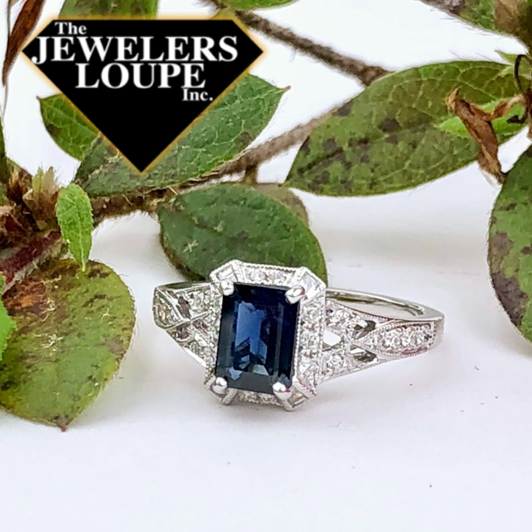 Vintage Style Ring set with 1.10ctw Emerald Cut Sapphire with .50ctw Diamonds set in 14K White Gold.