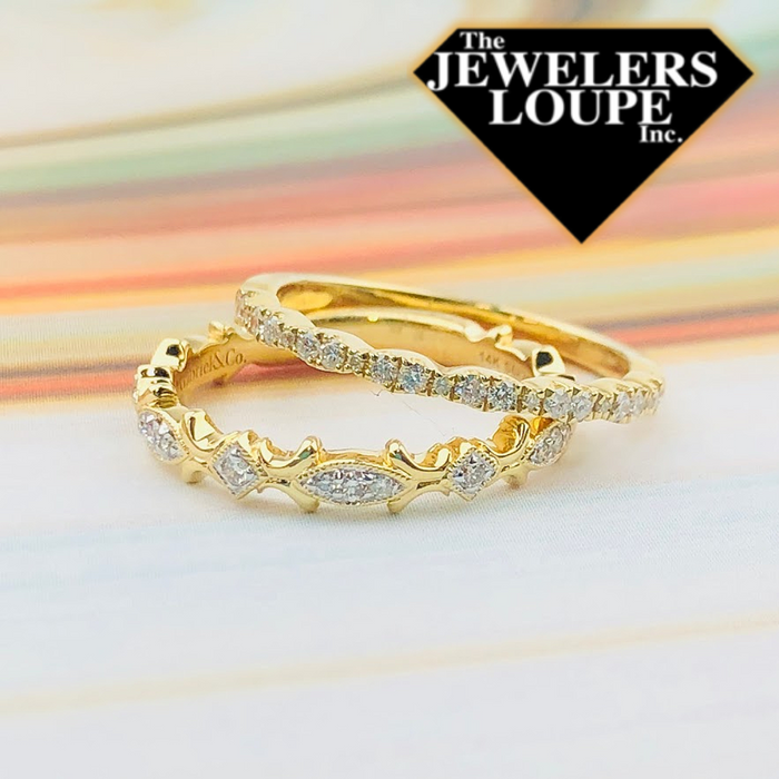 This delicate 14K Yellow Gold stackable ring features .18ctw graduated round diamonds in a repeating scalloped pattern.