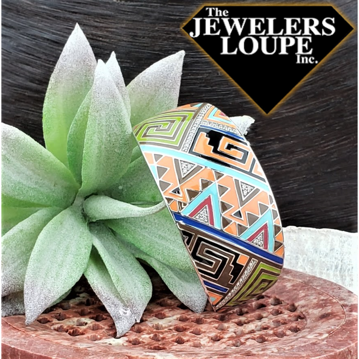 Like the marvelous natural rock formations found in the southwest, Sedona expresses an intricate triangular mosaic of sharp shapes and lines. Luminous stones peek through the rich vibrant color palette of hand-painted Italian enamels.